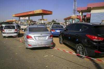 Sudanese people line up for fuel outside a petrol station in the capital Khartoum on February 11, 2020. More than a year after the start of a nationwide protest movement that led to the ouster of longtime ruler Omar al-Bashir last April, Sudan faces a series of challenges driven by an economic crisis. Months after he was ousted, the economy remains burdened with foreign debt of more than $60 billion, inflation of about 60 percent, soaring unemployment and chronic shortage of fuel and foreign currency. / AFP / ASHRAF SHAZLY
