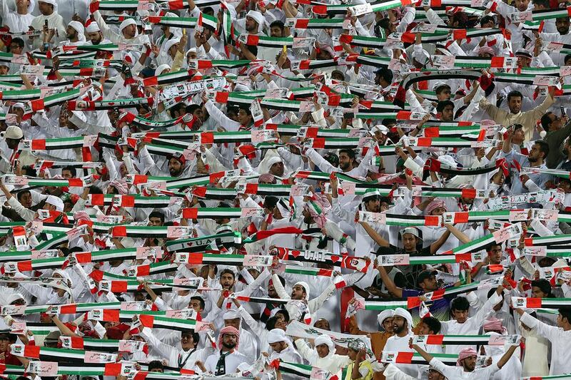 UAE fans hold up scarves during Tuesday night's World Cup qualifying match agains Saudi Arabia at the Mohammed bin Zayed Stadium in Abu Dhabi. Satish Kumar / The National / March 29, 2016