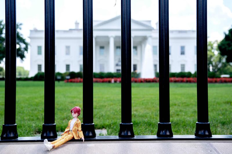 The Jungkook doll sits at the gates of the White House. AFP