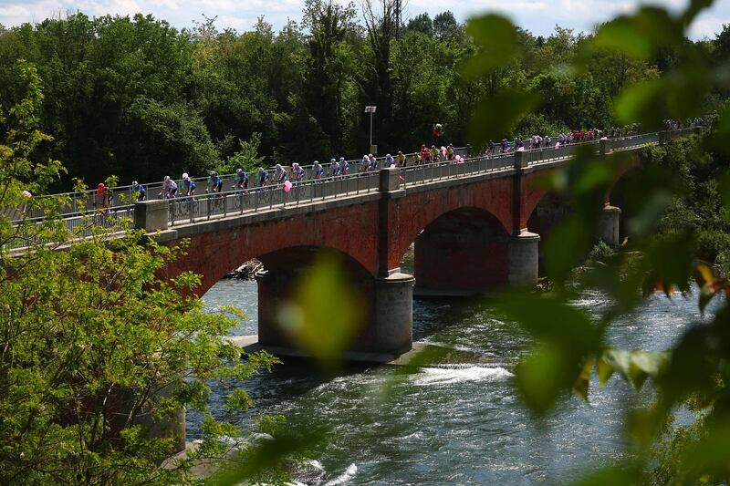 The peloton crosses a bridge over the Dora Riparia river near Villareggia.  AFP
