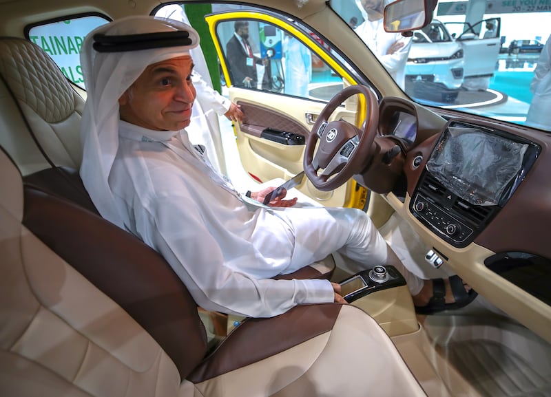 A visitor looks at the interiors of the Zhidou D2s EV on display at the Electric Vehicle Innovation Summit, ADNEC. Victor Besa / The National