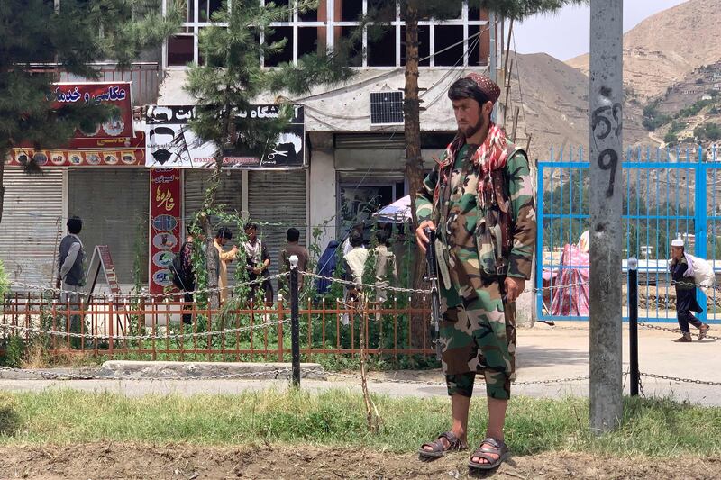 A member of the Afghan Taliban near the site of a suicide attack in Faizabad district of Badakhshan province on Tuesday. AFP