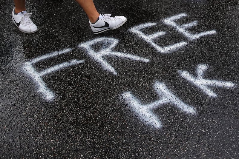 Protesters walk during an Anti-ERO (Emergency Regulations Ordinance) demonstration against a newly imposed law banning face masks in public in Hong Kong. EPA