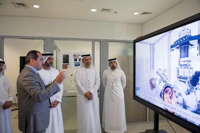 Sheikh Hamed speaks with a teacher at Khalifa University. Also seen is Dr Arif Al Hammadi, Executive Vice President of Khalifa University, third left.