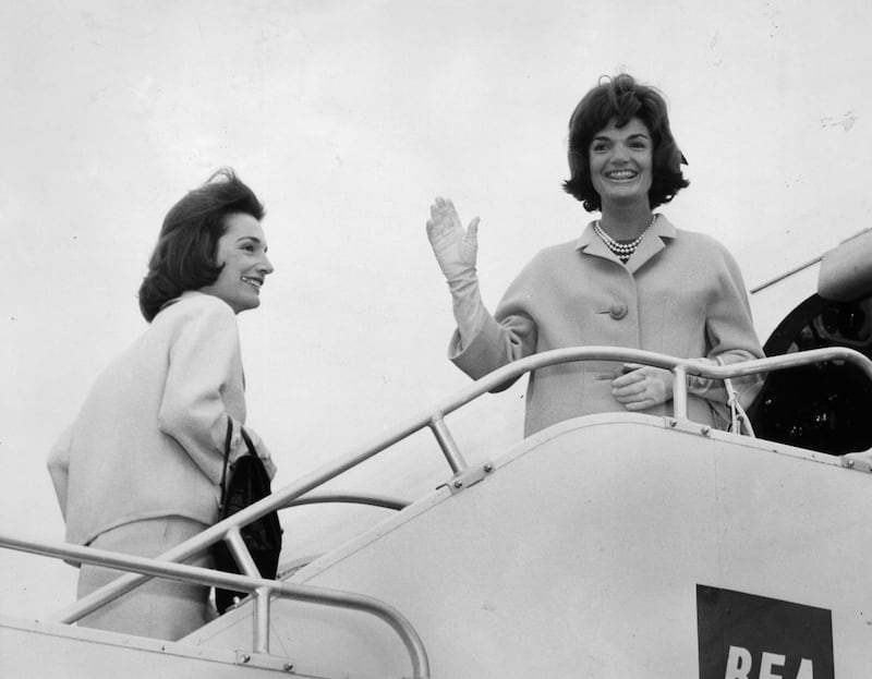 Jackie Kennedy boards a plane with her sister, Lee Radziwill. Getty Images