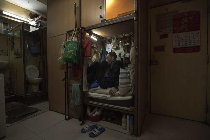 Wong Tat-ming, 63, sits in his ‘coffin home’. It’s crammed with all his meagre possessions, including a sleeping bag, small colour TV and electric fan.