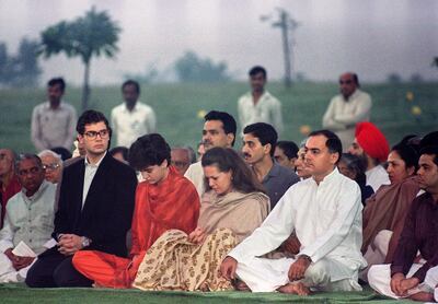 India's Premier Rajiv Gandhi (2nd-R), accompanied by his Italian-born wife Sonia (C) and his daughter Priyanka (2nd-L) and son Rahul (L), pray, on his mother, Indira Gandhi's, cremation site 31 October 1989 in New Delhi. Indira, a Congress party leader, was brutally assassinated by Sikh militants in 1984, a tragedy which thrust power onto Rajiv, who was then a commercial pilot of Indians Airlines. On 21 May 1991, Rajiv Gandhi, then Indian Prime minister, was assassinated by a woman activist allegedly belonging to Sri Lankan Liberation Tigers of Tamil Eelam (LTTE) rebels. Sonia, eleven years after the assassination of Rajiv, is leading a revival of the Congress party and carrying forward the legacy of India's most powerful political dynasty. AFP PHOTO DOUGLAS E. CURRAN (Photo by DOUGLAS E. CURRAN / AFP)