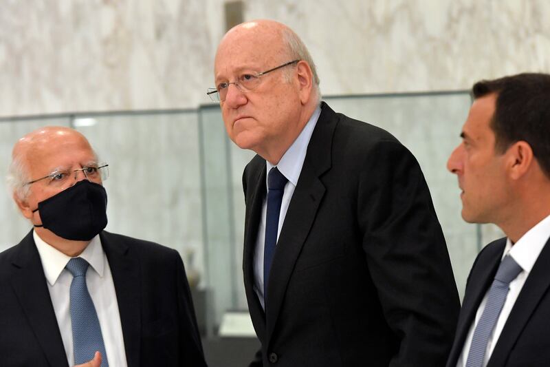 Lebanon's prime minister-designate Najib Mikati, centre, leaves the office of Lebanese President Michel Aoun after their meeting at the palace.