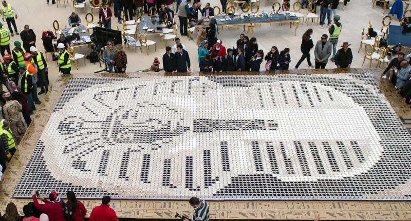 Media reports state that Guinness World Records organised the event to celebrate Egypt for 'breaking the world record with a picture of King Tutankhamun's mask' by using a total of 7,260 cups of coffee. EPA