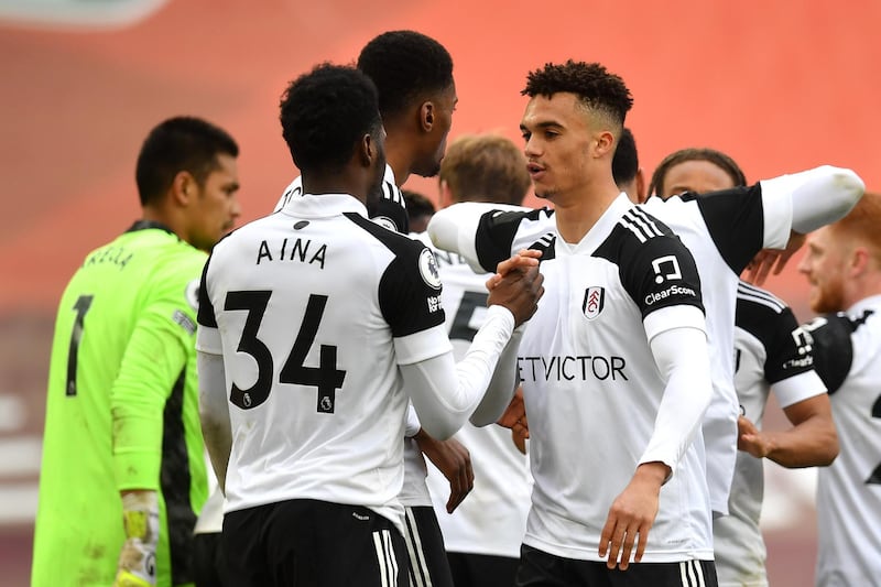 LIVERPOOL, ENGLAND - MARCH 07: Antonee Robinson of Fulham celebrates victory with team mate Ola Aina following the Premier League match between Liverpool and Fulham at Anfield on March 07, 2021 in Liverpool, England. Sporting stadiums around the UK remain under strict restrictions due to the Coronavirus Pandemic as Government social distancing laws prohibit fans inside venues resulting in games being played behind closed doors. (Photo by Paul Ellis - Pool/Getty Images)