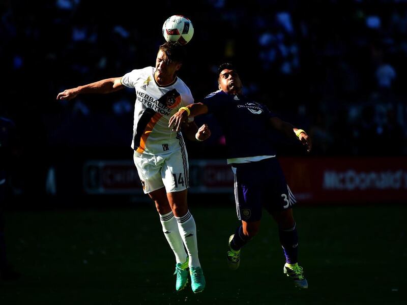 Robbie Rogers, number 14 of Los Angeles Galaxy, and Luke Boden, number 14 of Orlando City FC, jump for a header during a 4-2 Galaxy win at StubHub Center in Carson, California. Harry How / Getty Images / AFP