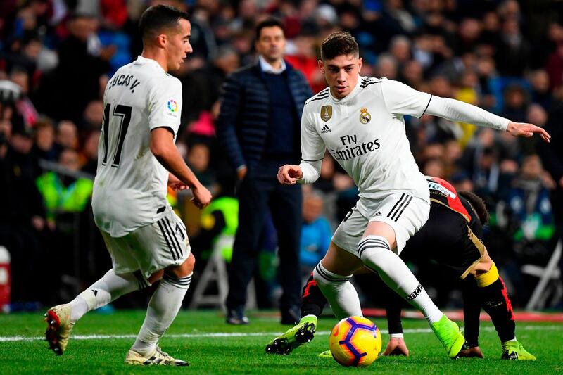 Real Madrid midfielder Federico Valverde, right, dribbles the ball during the match against Rayo Vallecano. AFP