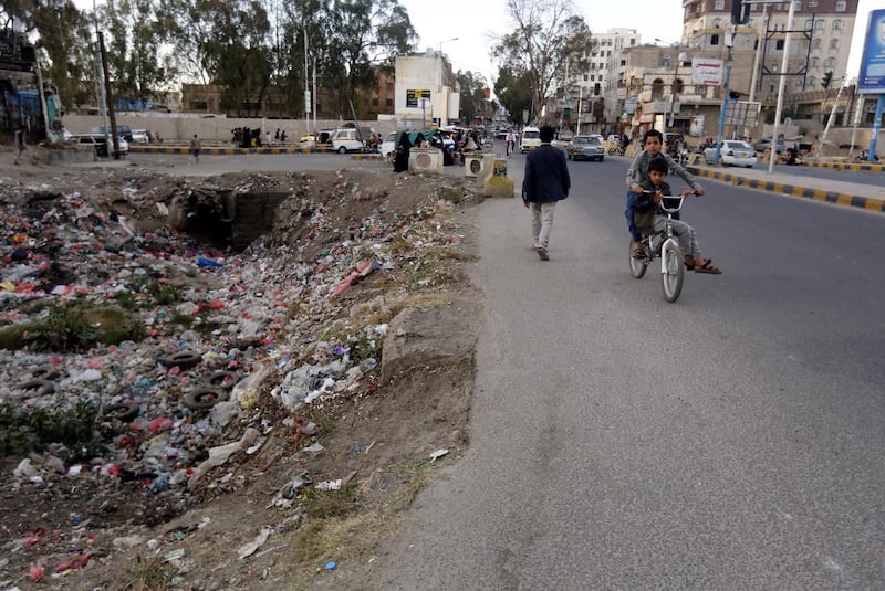 Yemenis pass a sewage swamp covered with waste, creating a high-risk environment for cholera, amid a rapidly spreading cholera outbreak, in Sana'a, Yemen.  EPA