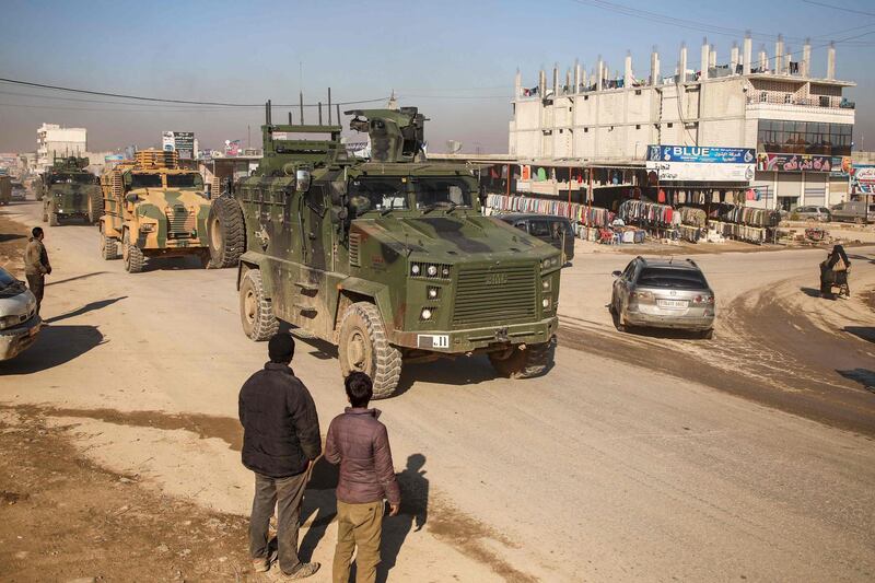 A Turkish military convoy of tanks and armoured vehicles passes through the Syrian town of Dana, east of the Turkish-Syrian border in the northwestern Syrian Idlib province.  AFP