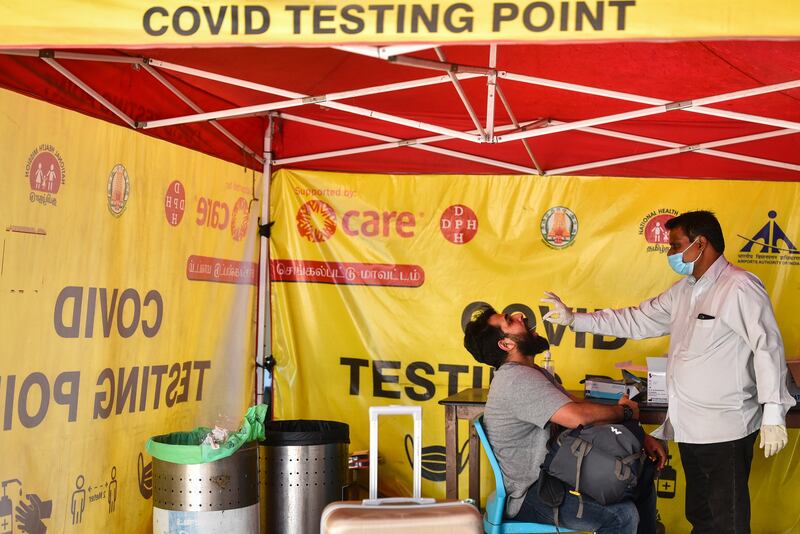 Under tightened Covid-19 rules, a passenger is tested for the coronavirus after arriving at Chennai International Airport, in eastern India. EPA