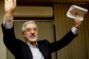 FILE - This Friday, June 12, 2009, file photo, shows Iranian reformist presidential candidate Mir Hossein Mousavi waving to the media during a late night press conference after polls closed in Tehran. A website long associated with detained opposition leader Mir Hossein Mousavi has quoted him as comparing a crackdown on protesters under Iran’s supreme leader to another carried out under the country’s ousted shah. The comments published Saturday, Nov. 30, 2019, represent some of the harshest yet attributed to Mousavi, a 77-year-old politician whose disputed election loss in 2009 led to widespread protests before being put down by security forces. (AP Photo/Kamran Jebreili)