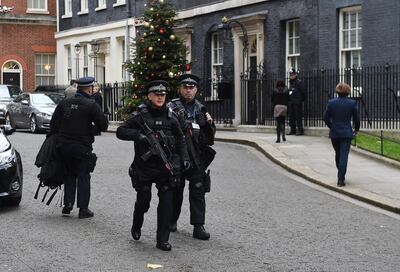 epa06370950 Armed policeman walk past British Prime Minister Theresa May's residence in 10 Downing Street in central London, Britain, 06 December 2017. Media reports on 06 December 2017 state that two men arrested last week have been charged with terrorism offences related to allegedly planning to bomb Downing Street security gates and then attack Prime Minister Theresa May with a knife.  EPA/ANDY RAIN