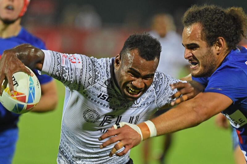 Jonathan Laugel of France (R) vies for the ball with Alasio Naduva (L) of Fiji during the HSBC Dubai Sevens Series men's rugby match between Fiji and France, at the Sevens Stadium in Dubai on December 6, 2019.  / AFP / KARIM SAHIB
