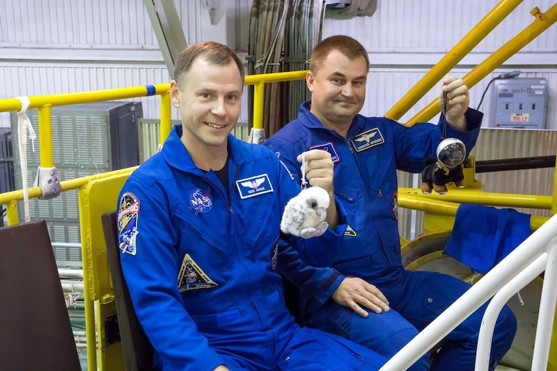 At the Baikonur Cosmodrome in Kazakhstan, Expedition 57 crewmembers Nick Hague of NASA (left) and Alexey Ovchinin of Roscosmos (right) hold up toy mascots Oct. 6 during final fit check activities prior to launch. The mascots will be mounted over their heads in the Soyuz MS-10 spacecraft to serve as “zero-G” indicators when they launch Oct. 11 for a six-month mission on the International Space Station...NASA/Victor Zelentsov.