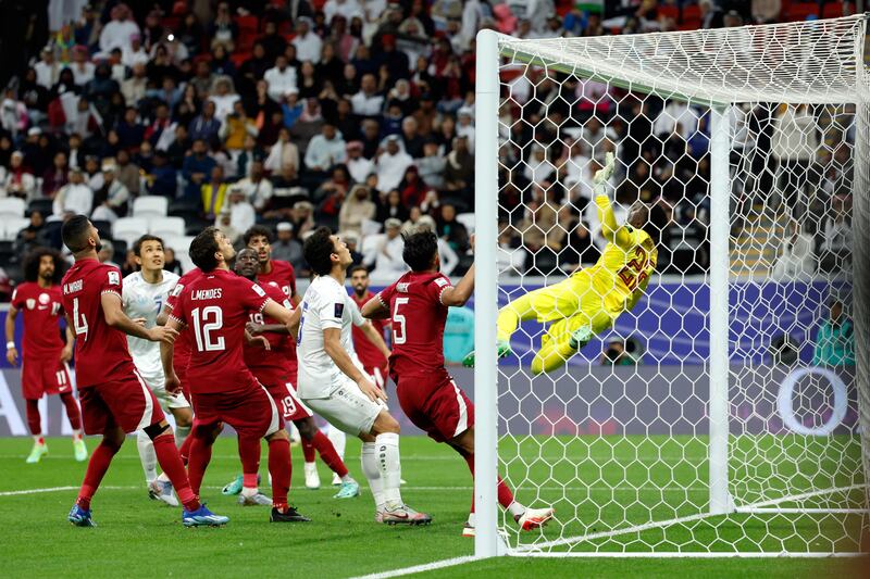 Qatar's goalkeeper Meshaal Barsham makes a spectacular save. AFP