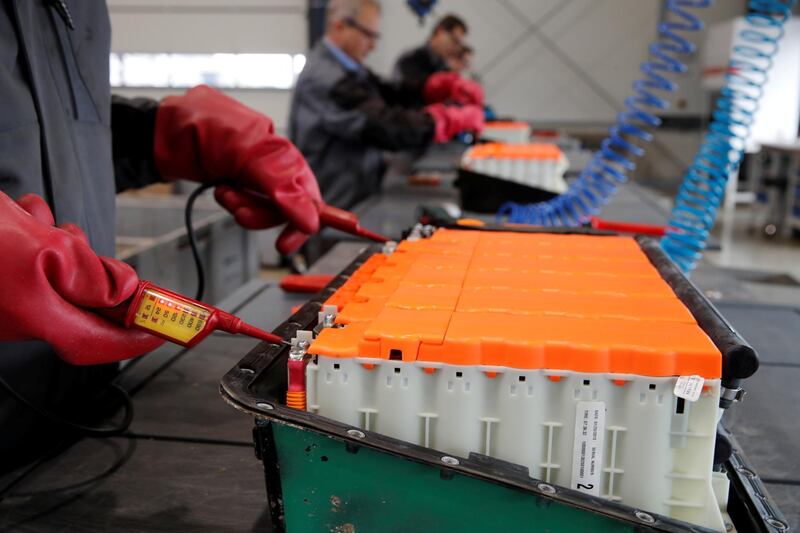 REFILE-CLARIFYING CAPTION The remaining voltage of a used Lithium-ion car battery is checked before its dismantling by an employee of the German recycling firm Accurec in Krefeld, Germany, November 16, 2017. Picture taken November 16, 2017.   REUTERS/Wolfgang Rattay