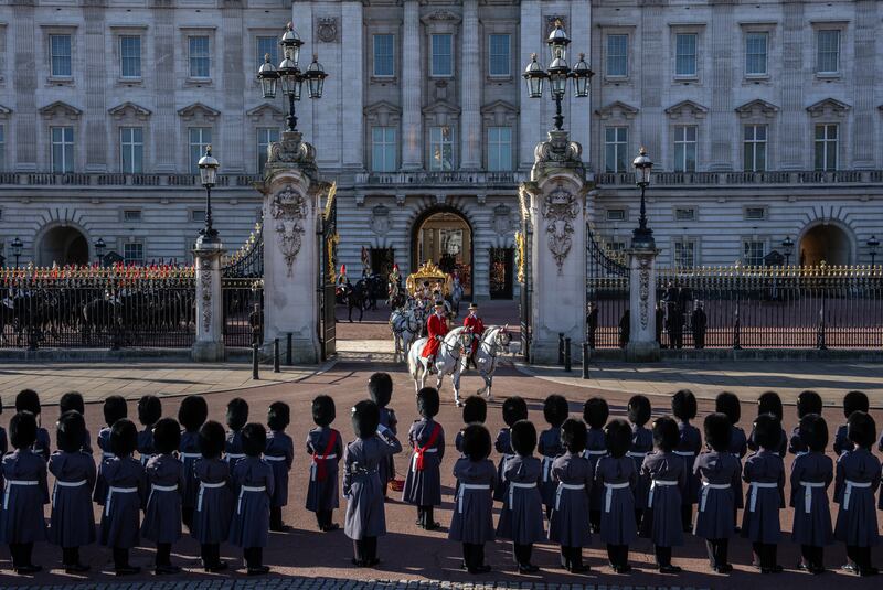 Members of the King's Guard line up outside Buckingham Palace as the royal couple depart. Getty Images