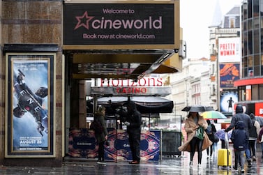 People walk past a Cineworld in Leicester's Square. Services have been hit hard across the UK and eurozone, as consumer-facing service providers report the steepest downturns. Reuters