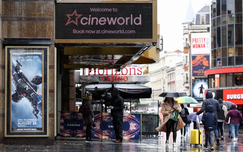 FILE PHOTO: People walk past a Cineworld in Leicester's Square, amid the coronavirus disease (COVID-19) outbreak in London, Britain, October 4, 2020. REUTERS/Henry Nicholls/File Photo