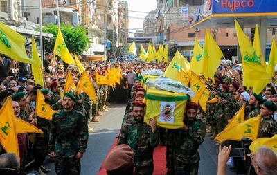 Members of Lebanon's Shiite Hezbollah movement carry the coffin of their fellow comrades, who were killed in Israeli strikes in Syria, during the funeral in the Ghobeiry neighbourhood of southern Beirut on August 26, 2019. The head of Hezbollah Hassan Nasrallah said on August 25 that Israeli strikes overnight in Syria had hit a position used by his Lebanese Shiite group, killing two of its members.
 / AFP / -
