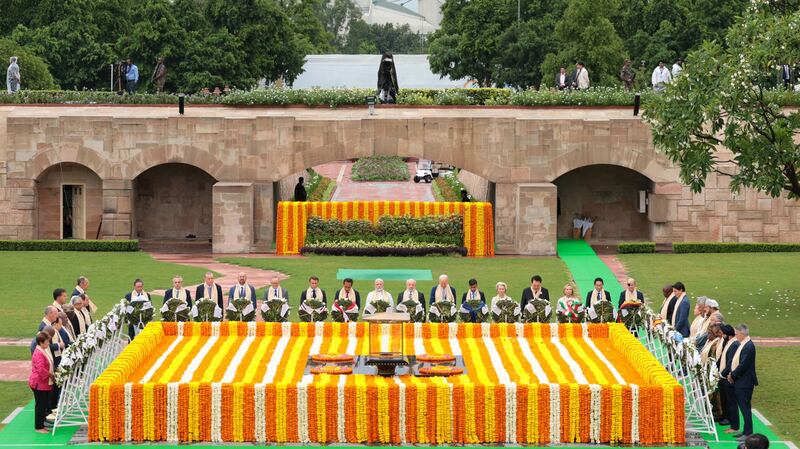 India's Prime Minister Narendra Modi (C) along with world leaders pays respect at the Mahatma Gandhi memorial at Raj Ghat on the sidelines of the G20 summit in New Delhi. AFP