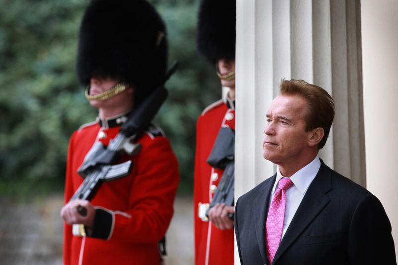LONDON, ENGLAND - OCTOBER 14:  The Governor of California Arnold Schwarzenegger watches The Changing of the Guard ceremony at Wellington Barracks on October 14, 2010 in London, England. Earlier The Governor and Mr Cameron held a meeting in Downing Street earlier today.  (Photo by Peter Macdiarmid/Getty Images)