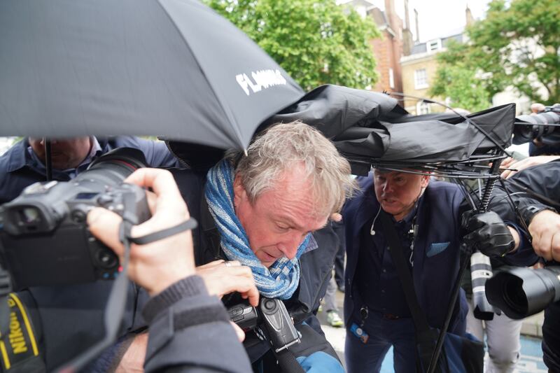  Kurt Zouma is hidden from photographers underneath umbrellas as he arrives in court. PA