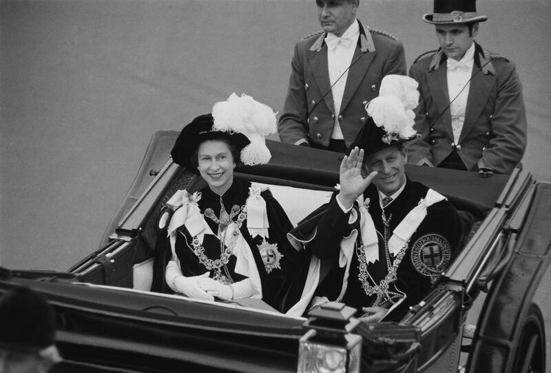 Prince Philip, Duke of Edinburgh and Queen Elizabeth II wave to crowds during the Garter Procession at Windsor Castle, 1969. (Photo by Victor Blackman/Daily Express/Hulton Archive/Getty Images)