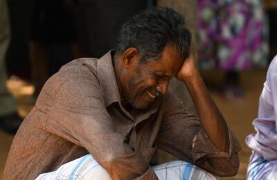 A relative of a Sri Lankan victim of an explosion at a church weeps outside a hospital in Batticaloa in eastern Sri Lanka on April 21, 2019. A series of eight devastating bomb blasts ripped through high-end hotels and churches holding Easter services in Sri Lanka on April 21, killing nearly 160 people, including dozens of foreigners. / AFP / LAKRUWAN WANNIARACHCHI
