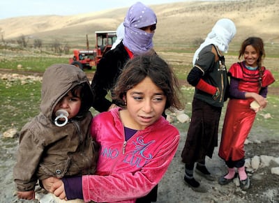 SINJAR, IRAQ - DECEMBER 20: Yezidis, fled from Islamic State of Iraq and Levant (ISIL) forces' attacks on their home town Sinjar, stay in harsh conditions as the winter starts, in a valley of western Sinjar Mountain in Sinjar district of Mosul, Irak on December 20, 2014. Yezidi women and children are seen out side of the tents. (Photo by Emrah Yorulmaz/Anadolu Agency/Getty Images)