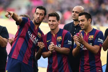Barcelona midfielder Sergio Busquets (L), Barcelona forward Lionel Messi and Barcelona Xavi stand during an official team presentation before a pre-season friendly on Monday. Josep Lago / AFP / August 18, 2014 