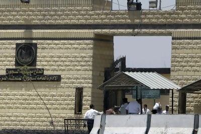 Policemen and people walk in front of the main gate of Tora prison. Reuters