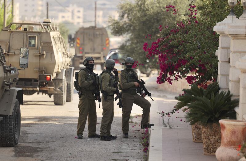 Israeli soldiers keep position during a military operation in the Palestinian town of Silwad, in the occupied West Bank. AFP