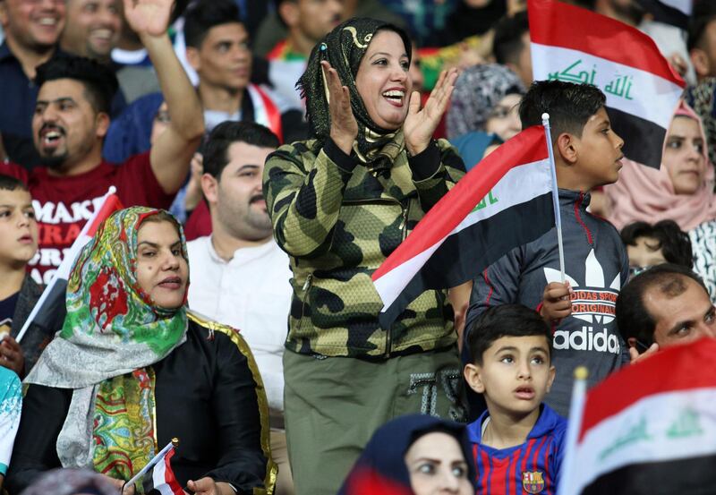 Iraqi fans cheer on their team during the international friendly football match between Iraq and Saudi Arabia at the Basra Sports city stadium in Basra on February 28, 2018. 
Iraq has not played full internationals on home turf ever since its 1990 invasion of Kuwait that sparked an international embargo. Iraq won the match 4-1 / AFP PHOTO / HAIDAR MOHAMMED ALI