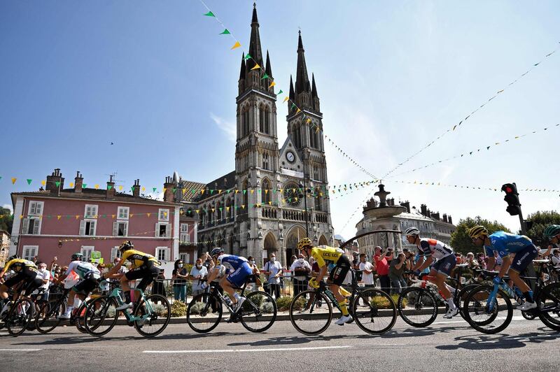 The peloton ride past the Saint Bruno Church of Voiron during Stage 16. AFP