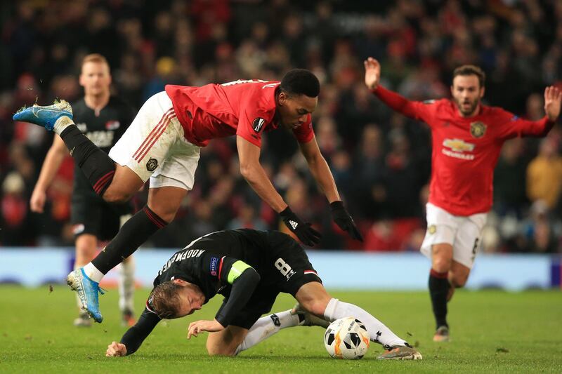 AZ Alkmaar's Dutch midfielder Teun Koopmeiners, below, and Manchester United's Anthony Martial collide. AFP