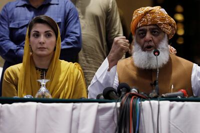 Fazal-ur Rehman, of the Jamiat Ulema-e-Islam-Fazal (JUI-F) and president of the Pakistan Democratic Movement (PDM), an alliance of political opposition parties, along with Maryam Nawaz, the daughter of Pakistan's former Prime Minister Nawaz Sharif address a news conference in Karachi, Pakistan October 19, 2020. REUTERS/Akhtar Soomro