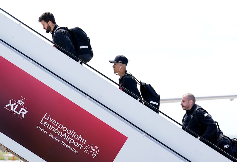 Liverpool's Roberto Firmino and goalkeeper Alisson board the plane before flying out of John Lennon Airport, ahead of the Champions League final in Paris on Saturday. PA