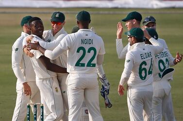 South Africa's pacer Kagiso Rabada, second left, celebrates with teammates after taking the wicket of Pakistan's batsman Imran Butt during the first day of the first cricket test match between Pakistan and South Africa at the National Stadium, in Karachi, Pakistan, Tuesday, Jan. 26, 2021. (AP Photo/Anjum Naveed)