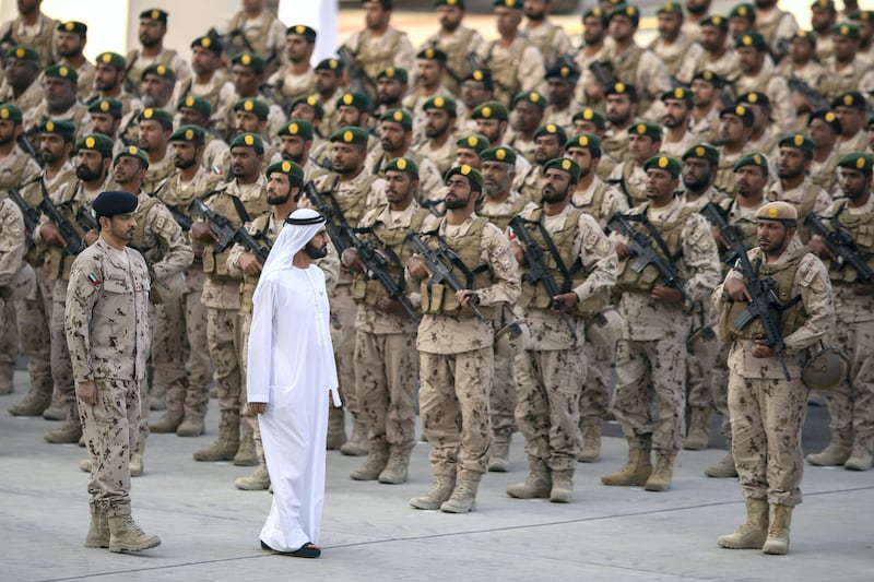Sheikh Mohammed bin Rashid, Ruler of Dubai and Prime Minister and Minister of Defence (second left), inspects military personnel during the reception at Zayed Military City.