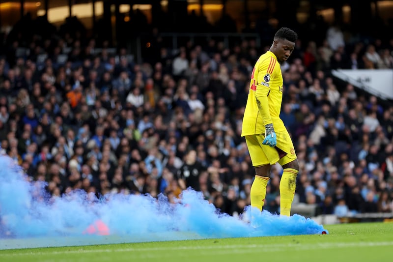 Andre Onana of Manchester United looks on as a flare is thrown on to the pitch. Getty Images