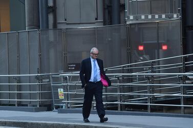 A city worker walks past the Lloyds building in the City of London, Britain. UK finance minister Rishi Sunak extended the country's coronavirus furlough scheme until the end of March last week to help cushion the blow of a second lockdown. EPA