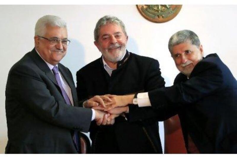 Palestinian President Mahmoud Abbas, left, shakes hands with his Brazilian counterpart Luis Inacio Lula da Silva and Brazilian Foreign Minister Celso Amorim in Brasilia last month.