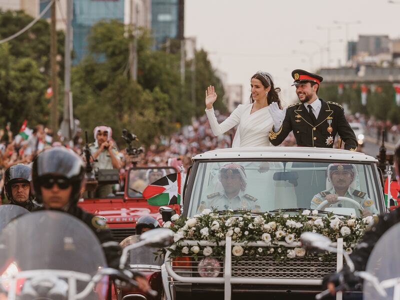 Jordanian Crown Prince Hussein bin Abdullah and his wife Princess Rajwa wave during their wedding parade in Amman. EPA