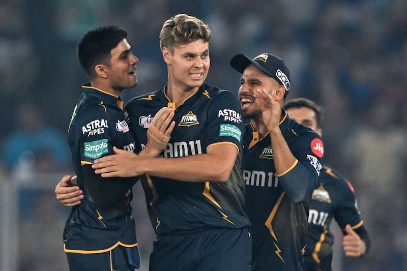 Gujarat Titans' Spencer Johnson, centre, bowled a superb penultimate over to help seal victory over Mumbai Indians in their IPL match at the Narendra Modi Stadium in Ahmedabad on Sunday, March 24, 2024. AFP